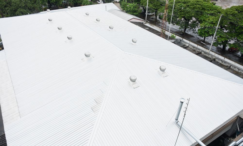 Large completed commercial metal roof with ridge ventilators